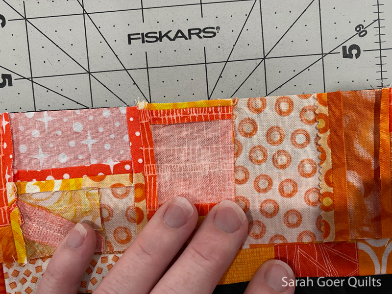 https://sarahgoerquilts.com/wp-content/uploads/2020/12/Orange-Improv-Log-Cabin-Mini-Quilt-bulk-in-seam2.jpg