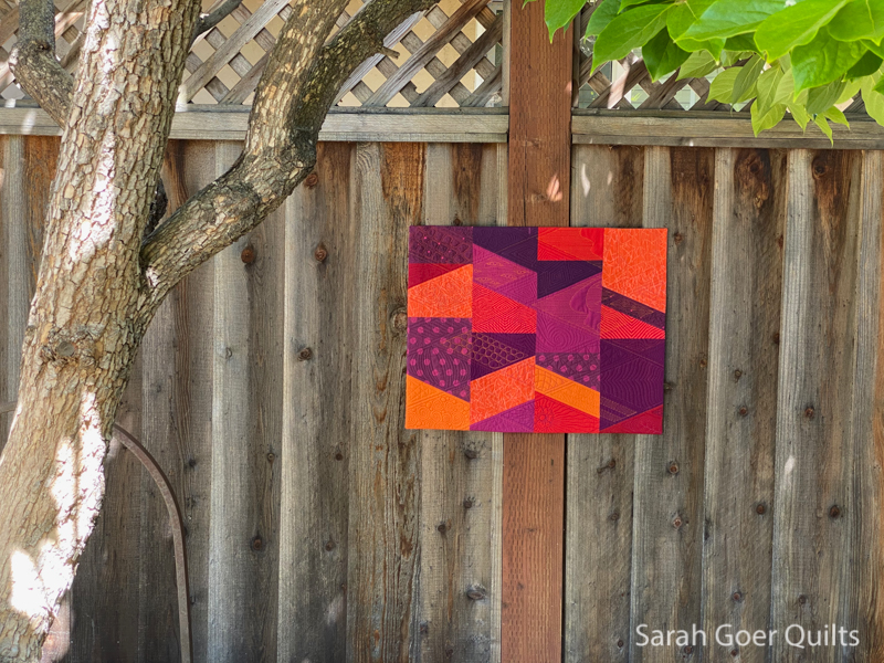 https://sarahgoerquilts.com/wp-content/uploads/2021/05/Sunset-All-About-Angles-on-fence.jpg