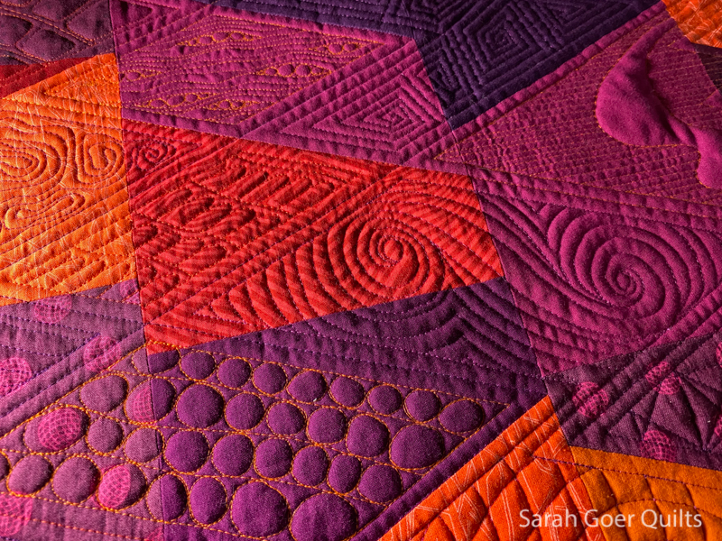 https://sarahgoerquilts.com/wp-content/uploads/2021/05/Sunset-All-About-Angles-quilting-texture-closeup.jpg